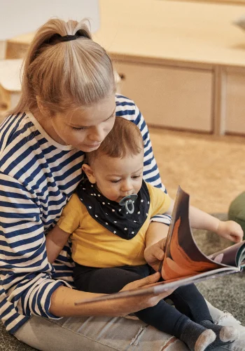 Teacher reading with a baby